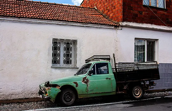 Old green truck parked in front of a house promoting cash for junk trucks in Loganville GA.
