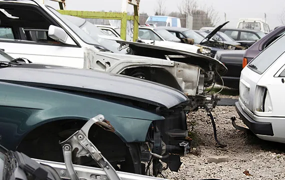 A large parking lot filled with various cars awaiting removal for hassle-free junk car services.